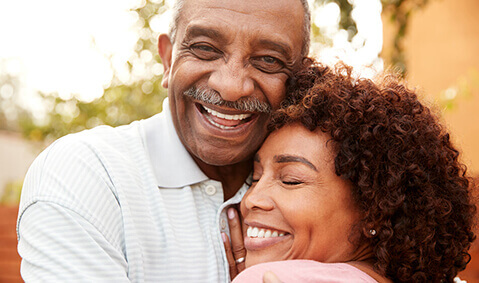 Happy older African american couple embracing.