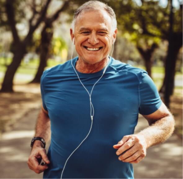Mature man jogging while listenting to music
