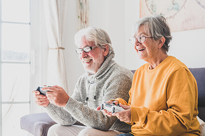 Mature couple playing video games